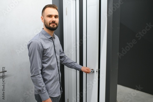 A man chooses doors in a hardware store for his apartment