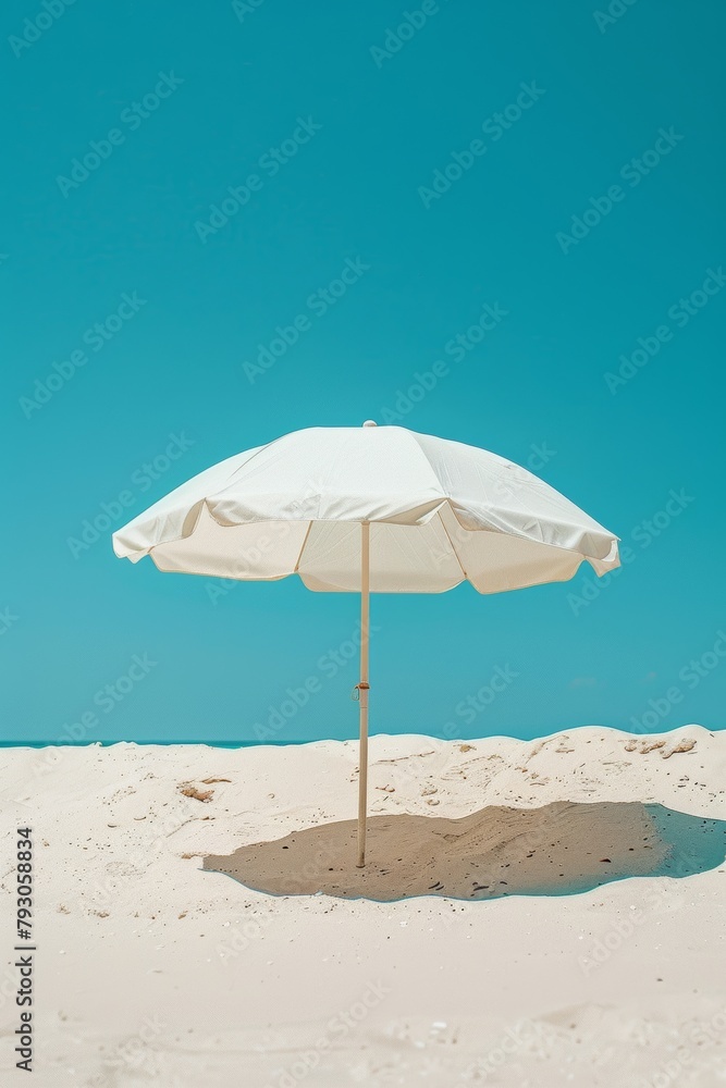A photo of a beach with a white beach umbrella. A photo of a beach with a white beach umbrella.