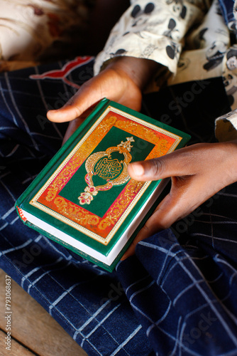 Young african boy reading the Koran.