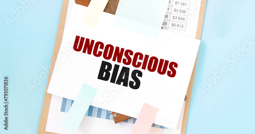 Unconscious Bias text on paper with colorful sticky notes and pencil on clipboard. Inclusive workplace and human resources concept © Andrey