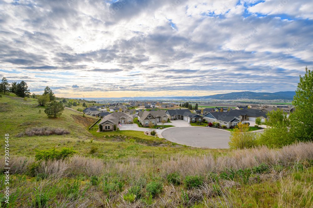 View from a hilltop in Liberty Lake, Washington, of a rural subdivision of homes with the cities of Spokane and Spokane Valley. in the distance. View from a hilltop in Liberty Lake, Washington, of a rural subdivision of homes with the cities of Spokane and Spokane Valley. in the distance.