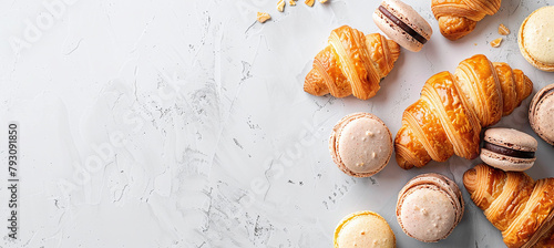 fresh croissants and macarons on a light background photo