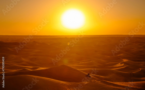 Dubai desert safari in sunset light. Off road safari in sand desert, Empty Quarter Desert in United Arab Emirates. Quad bike on dunes in Rub’ al Khali desert.