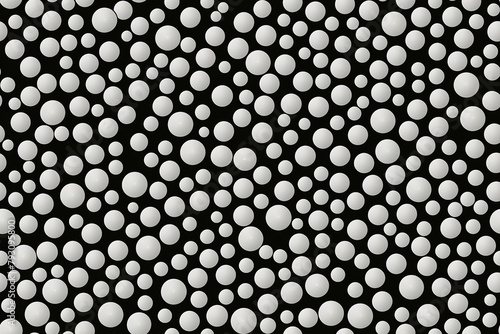 Seamless monochrome pattern with various sized white dots on a black background