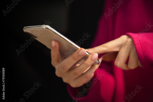 beautiful girl holding a smartphone in her hands in the office