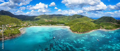 Panoramic aerial view of Carlisle Bay beach with lush rain forest and turquoise and emerald sea, Antigua and Barbuda, Caribbean