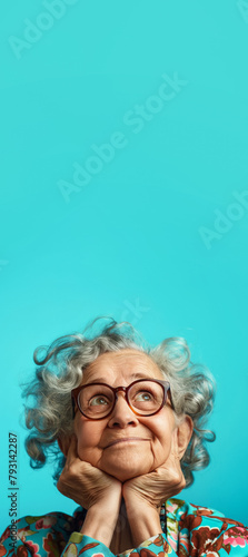 Funny looking elderly woman wearing glasses, dreamy face expression, looking up into empty copy space above as if thinking. Generative AI photo