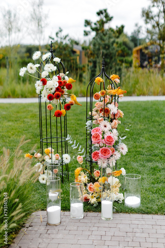 Pair of vases with flowers on sidewalk