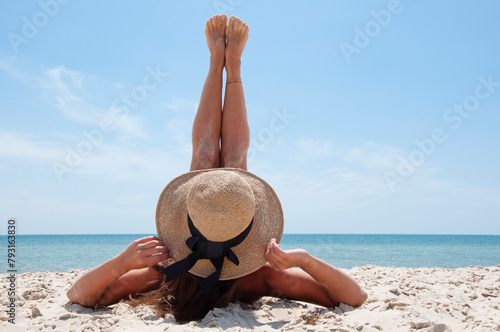 Summer vacation of woman in straw hat, copy space. Retro woman at sea beach. Suntan at summer beach. Beach vacation of retro girl. Sea travel resort. Woman on summer vacation at beach. Beauty