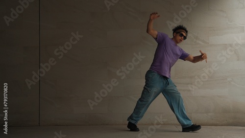 Skilled smart street dancer practice b-boy movement in building with gray background. Young handsome attractive choreographer perform energetic and active movement. Outdoor sport 2024. Sprightly. © Summit Art Creations