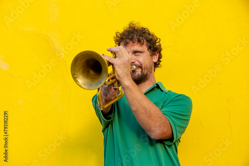 Inspirational one-armed trumpeter playing on city street photo