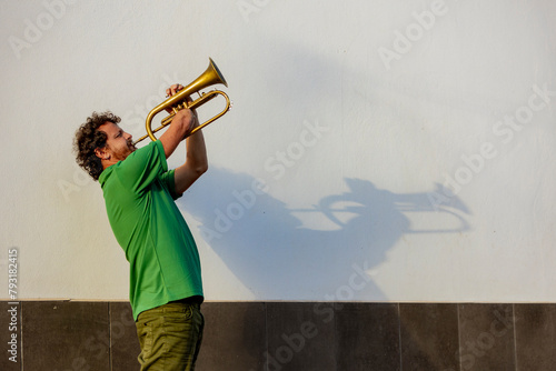 Inspiring one-armed trumpeter performs on the street photo