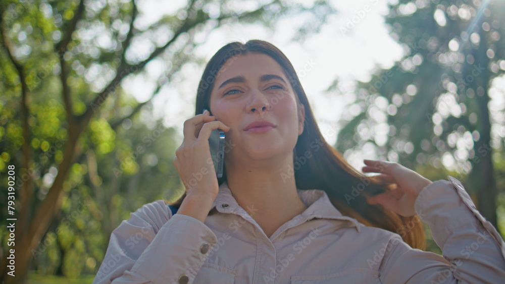 Positive lady enjoy phone conversation in summer park closeup. Woman talking Positive lady enjoy phone conversation in summer park closeup. Woman talking