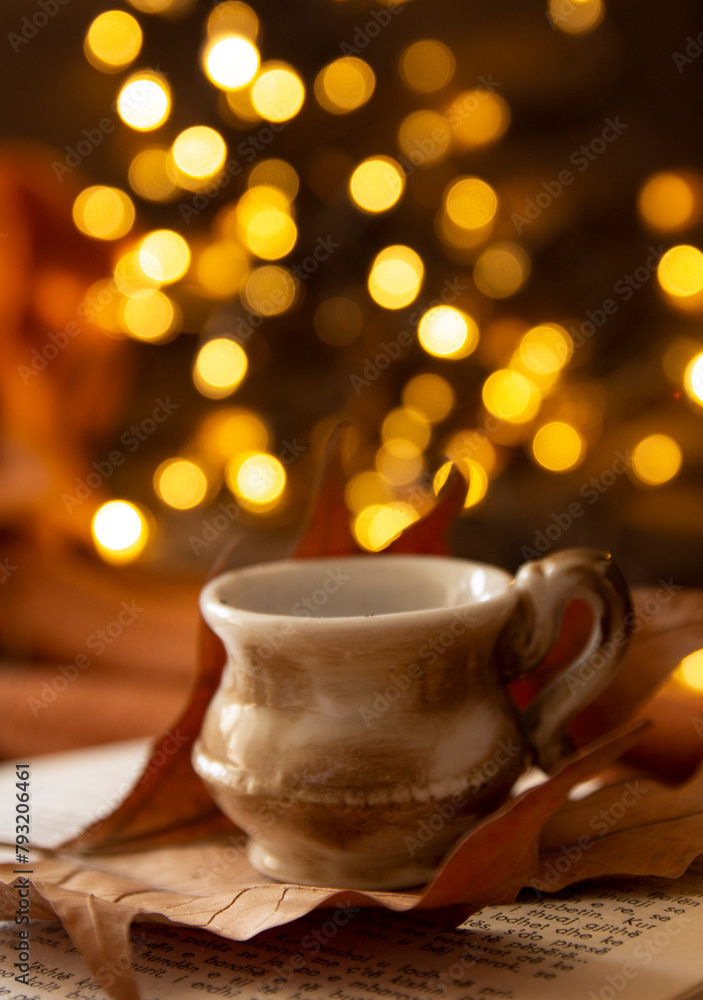 books, leaves, coffee cup and bokeh lights books, leaves, coffee cup and bokeh lights
