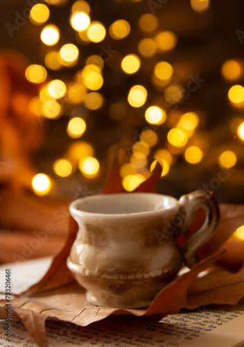 books, leaves, coffee cup and bokeh lights