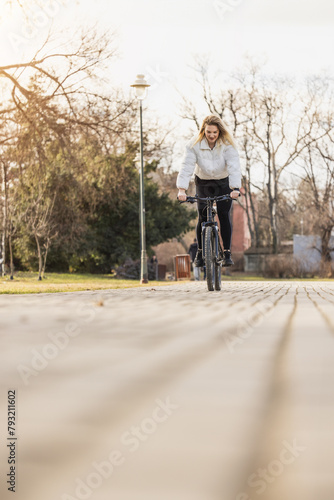 Woman Riding a Bike Down a Street