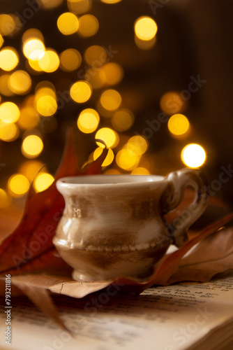 books, leaves, coffee cup and bokeh lights