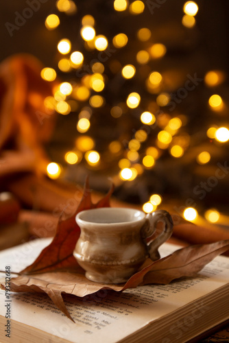 books, leaves, coffee cup and bokeh lights