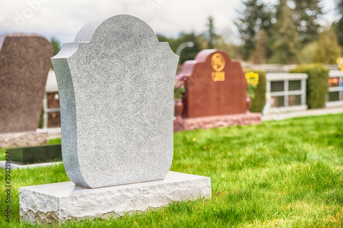 Large blank tombstone situated in cemetery.