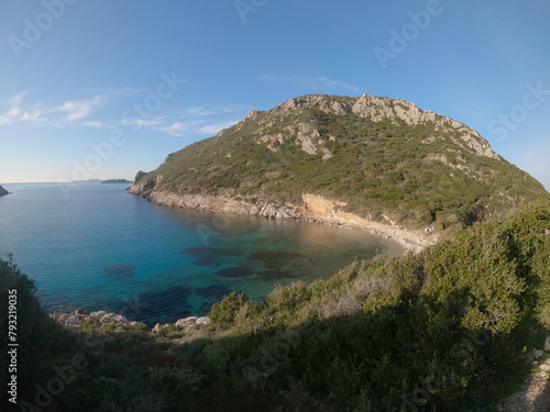 Sandy beach on Pirates Bay  Porto Timoni  Afionas village location. Amazing morning seascape of Ionian Sea. Colorful outdoor scene of Corfu island  Greece  Europe. Vacation concept background.