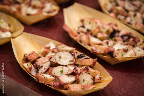 Close up. Appetizer, pieces of octopus in cardboard packaging.