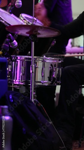 vertical video, young musician playing rock music on the drums. Fast and energetic drum playing, rock concert