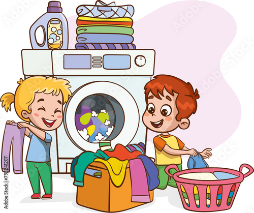 Happy little childrens doing daily chores with washing machine, holding a basket full of laundry.