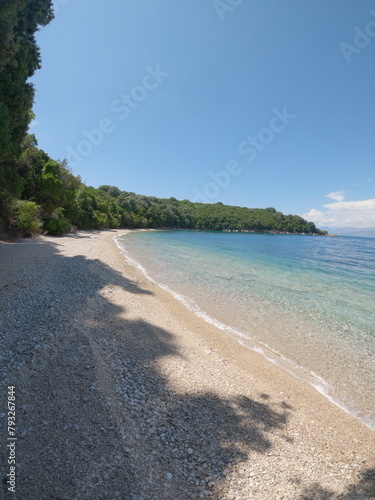 Secret beach in corfu island, Greece.  view to pristine beach with rocky bay and waves crashing