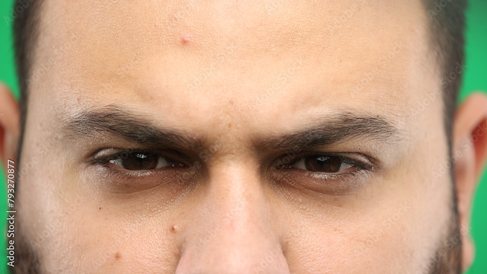 Man's eyes, close-up, on a green background
