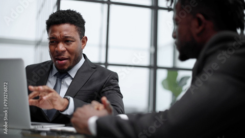 Confident male lawyer discussing project with businessman during office meeting