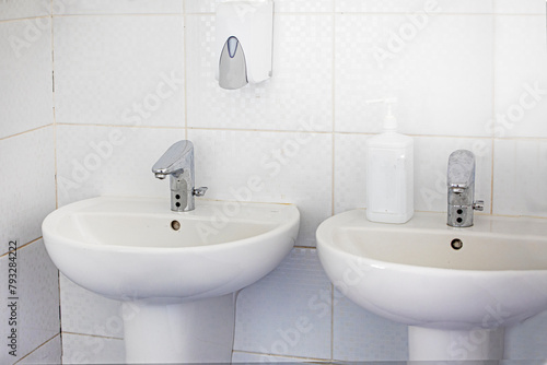 white sinks and faucets in the bathroom. modern design © Nataliia Makarovska