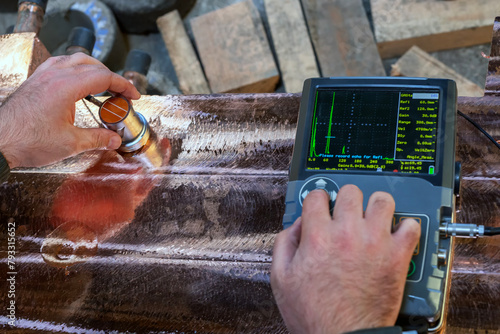 Operator performs ultrasonic inspection on copper casting. Ultrasonic testing (UT) is a family of non-destructive testing techniques based on the propagation of ultrasonic waves in the object.