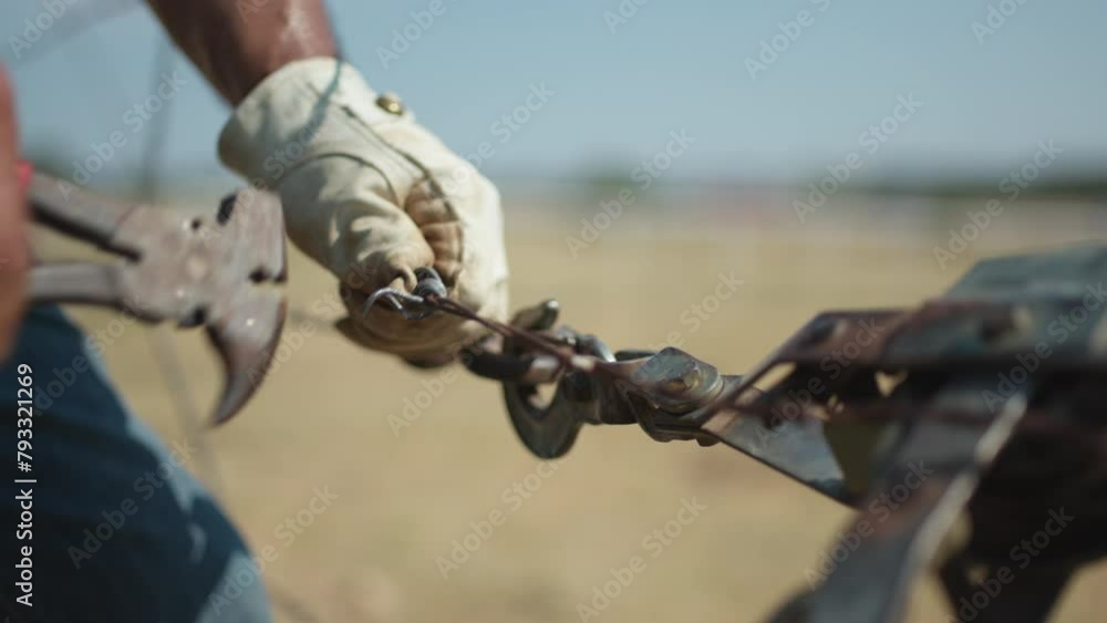 custom made wallpaper toronto digitalTight shot of a rancher fixing a barbed wire fence with gloves and tools