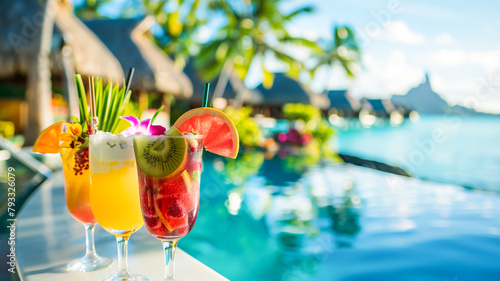 Tropical bright cocktails in glass with tropical flowers against a vibrant blue ocean backdrop