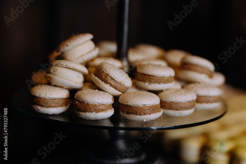 Macaroons Cakes with cream on a plate. Table with sweets, candies, dessert. Macaroons with chocolate
