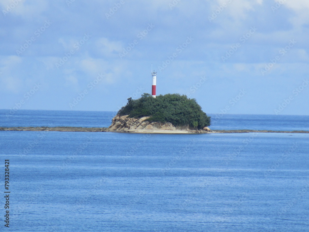 lighthouse on a rocky, forested small island