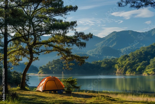 A tent is pitched by the lake  surrounded by trees under the open sky