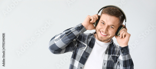 Handsome young man listenin...