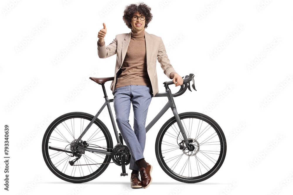 Young man leaning on a bicycle and gesturing thumbs up Young man leaning on a bicycle and gesturing thumbs up