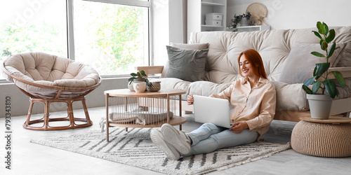 Young woman with laptop sit...