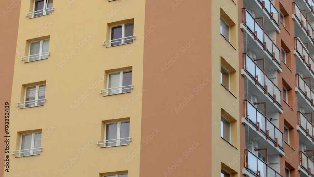 City living. Facade of a multi-story residential panel building with balconies. Witness the architectural symmetry and vibrant community life. Modern urban landscape. City living. Facade of a multi-story residential panel building with balconies. Witness the architectural symmetry and vibrant community life. Modern urban landscape.