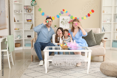 Parents with children sitti...