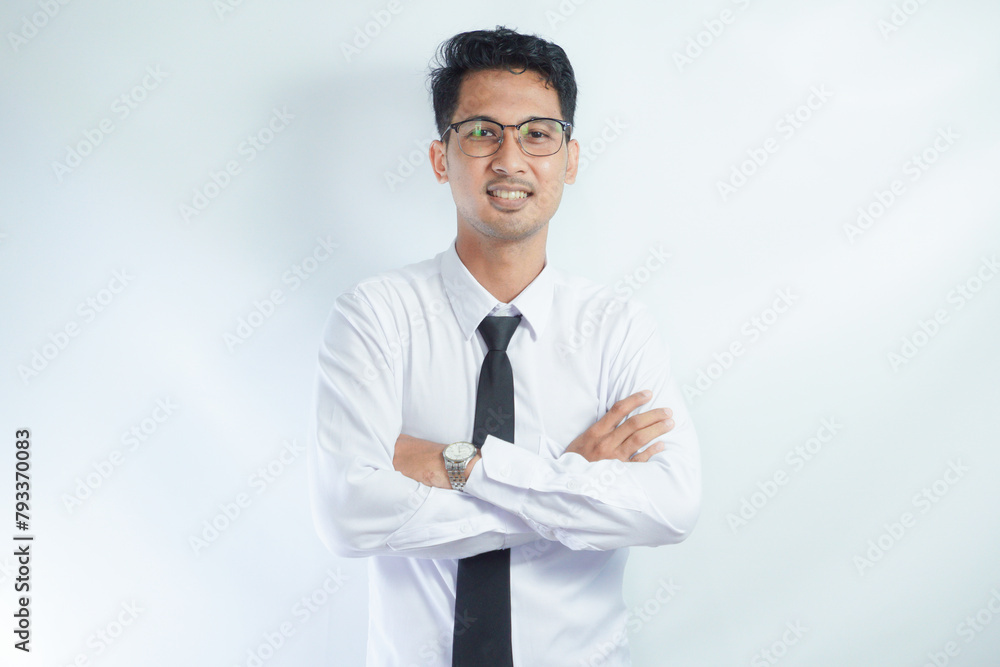 Young smiling cheerful Asian confident man he wears white shirt look camera hold hands crossed folded isolated on white background studio portrait. Lifestyle concept