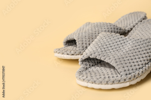 Grey slippers on yellow background