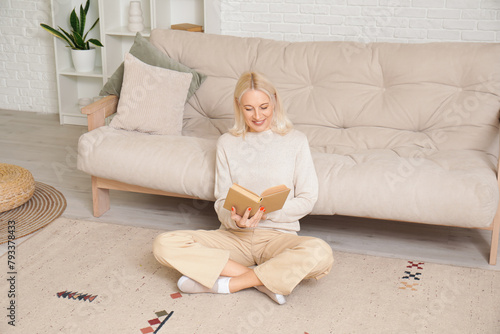 Mature woman reading book o...