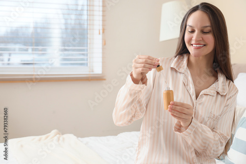 Young woman with bottle of ...