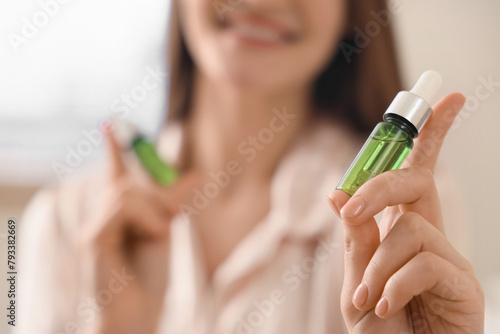 Young woman with bottle of ...