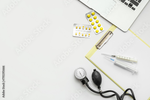 Medical supplies with laptop on white background. World Health Day
