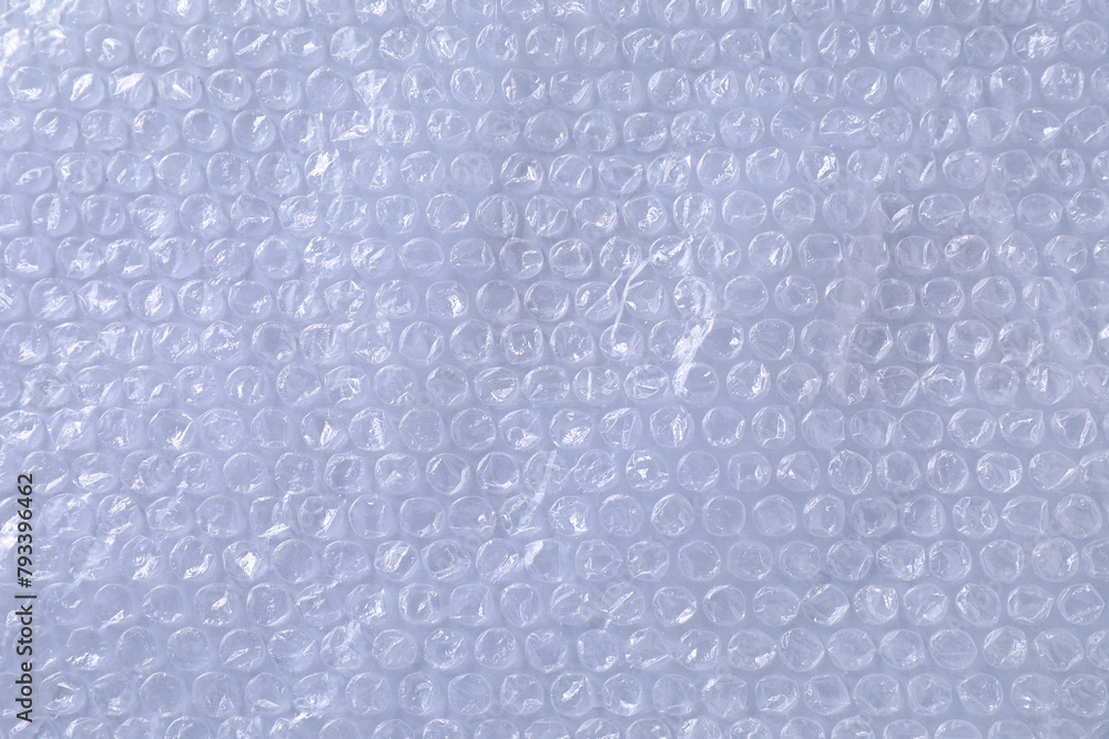 Obraz premium Transparent bubble wrap on gray background, top view
