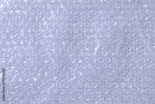 Transparent bubble wrap on gray background, top view photo